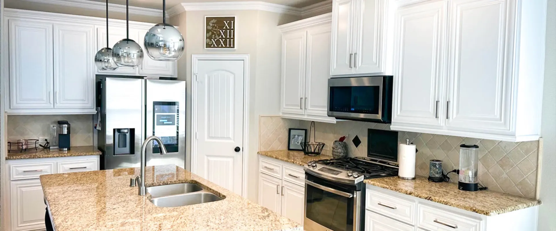 Freshly painted white kitchen cabinets and walls in a DFW home